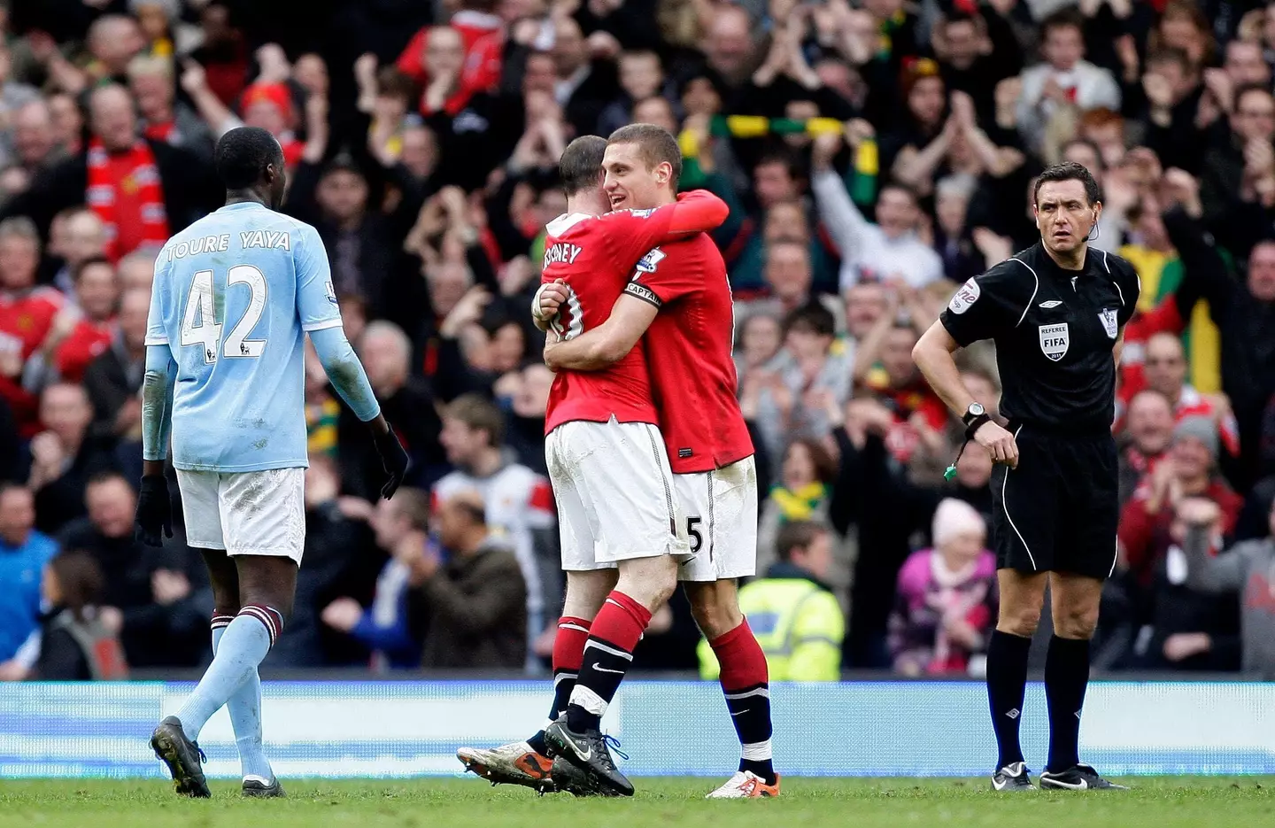 Rooney and Vidic embrace. Image: Alamy