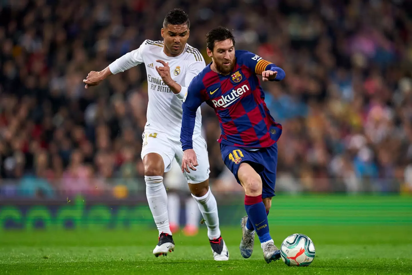 Casemiro and Lionel Messi battle for the ball (