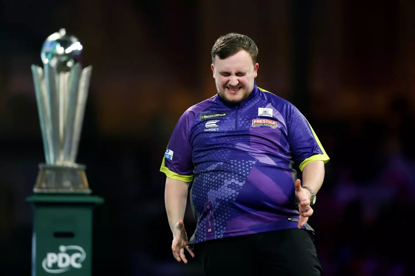 Luke Littler cuts a frustrated figure in the World Darts Championship final. Image: Getty