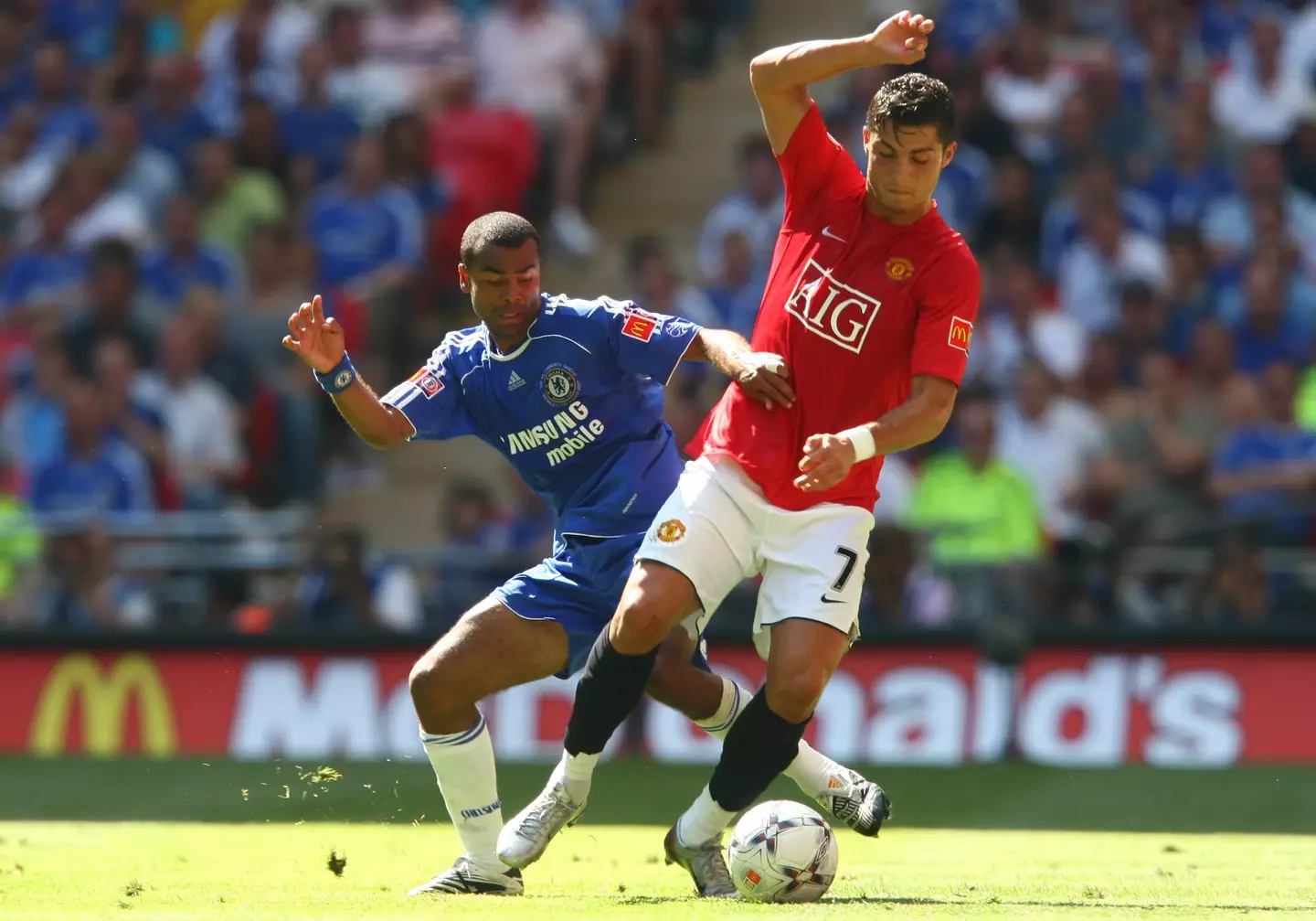 Man Utd forward Cristiano Ronaldo battles with Chelsea defender Ashley Cole (