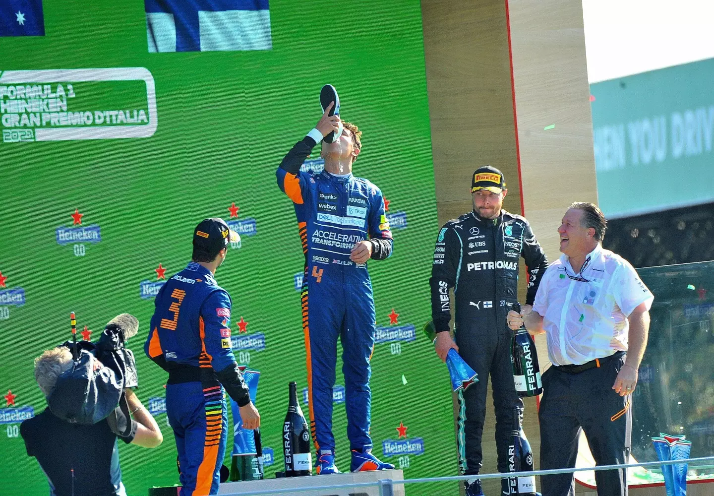 Lando 'enjoys' his first shoey, an experience he's unlikely to replicate. Image: PA Images