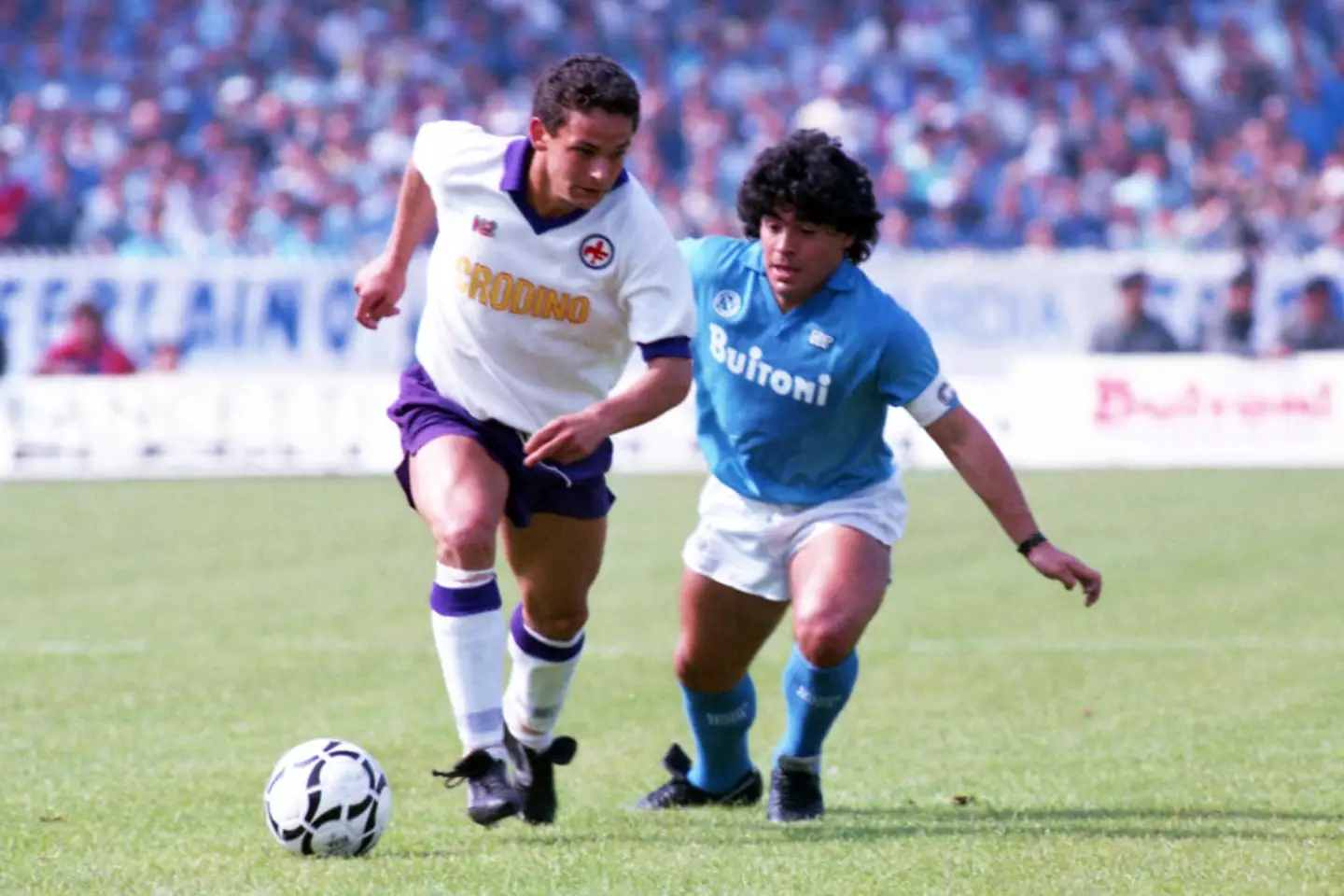 Roberto Baggio and Diego Maradona battle for the ball -