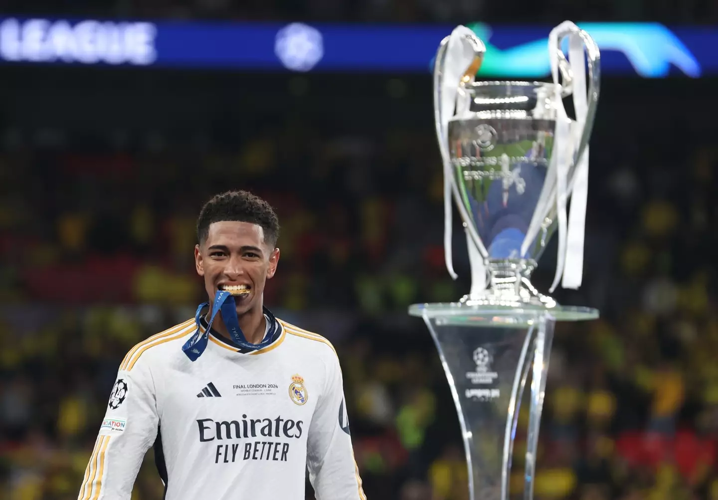 Jude Bellingham bites into his medal after winning the Champions League with Real Madrid. Image: Getty