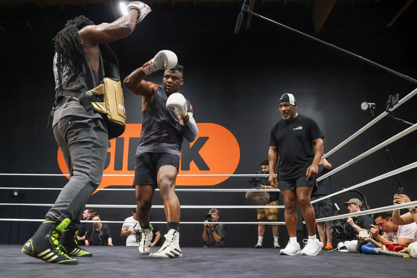 Mike Tyson watches on as Francis Ngannou trains. Image: Getty 