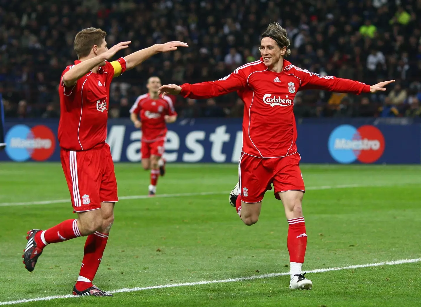 Fernando Torres celebrates a Liverpool goal with Steven Gerrard. Image: Getty