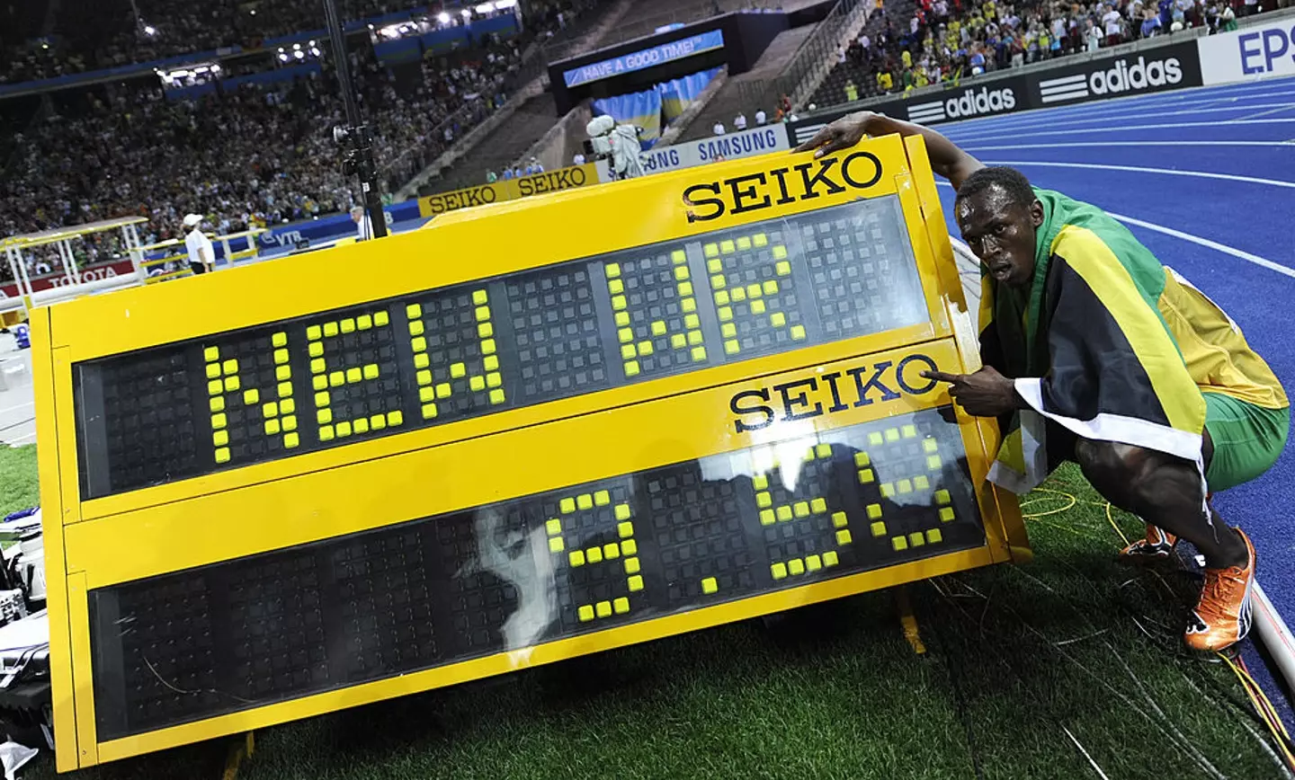 Usain Bolt points to his new 100m world record time of 9.58 at the London 2012 Olympics (