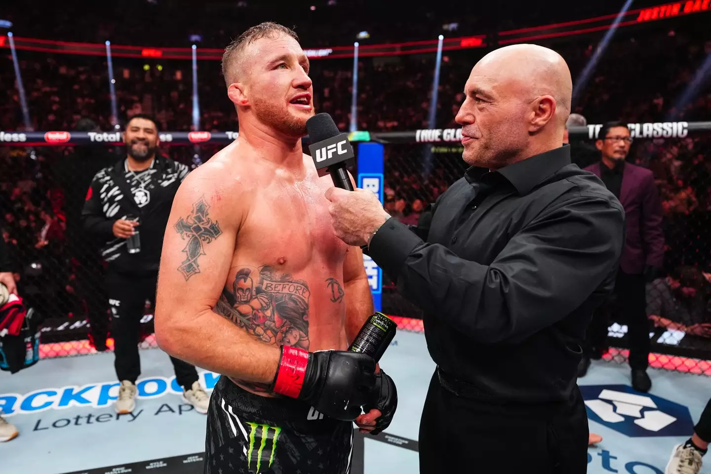 Justin Gaethje, who is wearing gloves without the UFC logo, speaks to Joe Rogan following his UFC 313 victory. Image: Getty