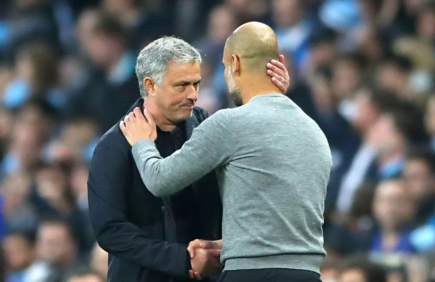 Jose Mourinho greets Pep Guardiola in a Manchester derby. PA Images / Alamy