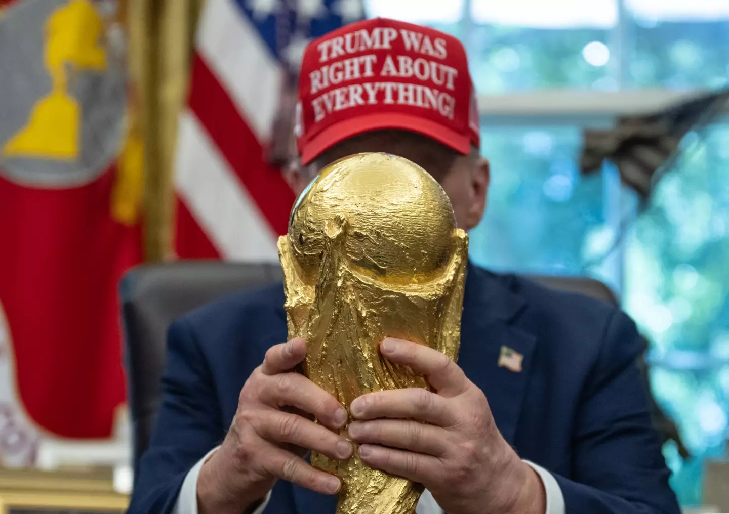 Donald Trump poses with the World Cup trophy. Image: Getty