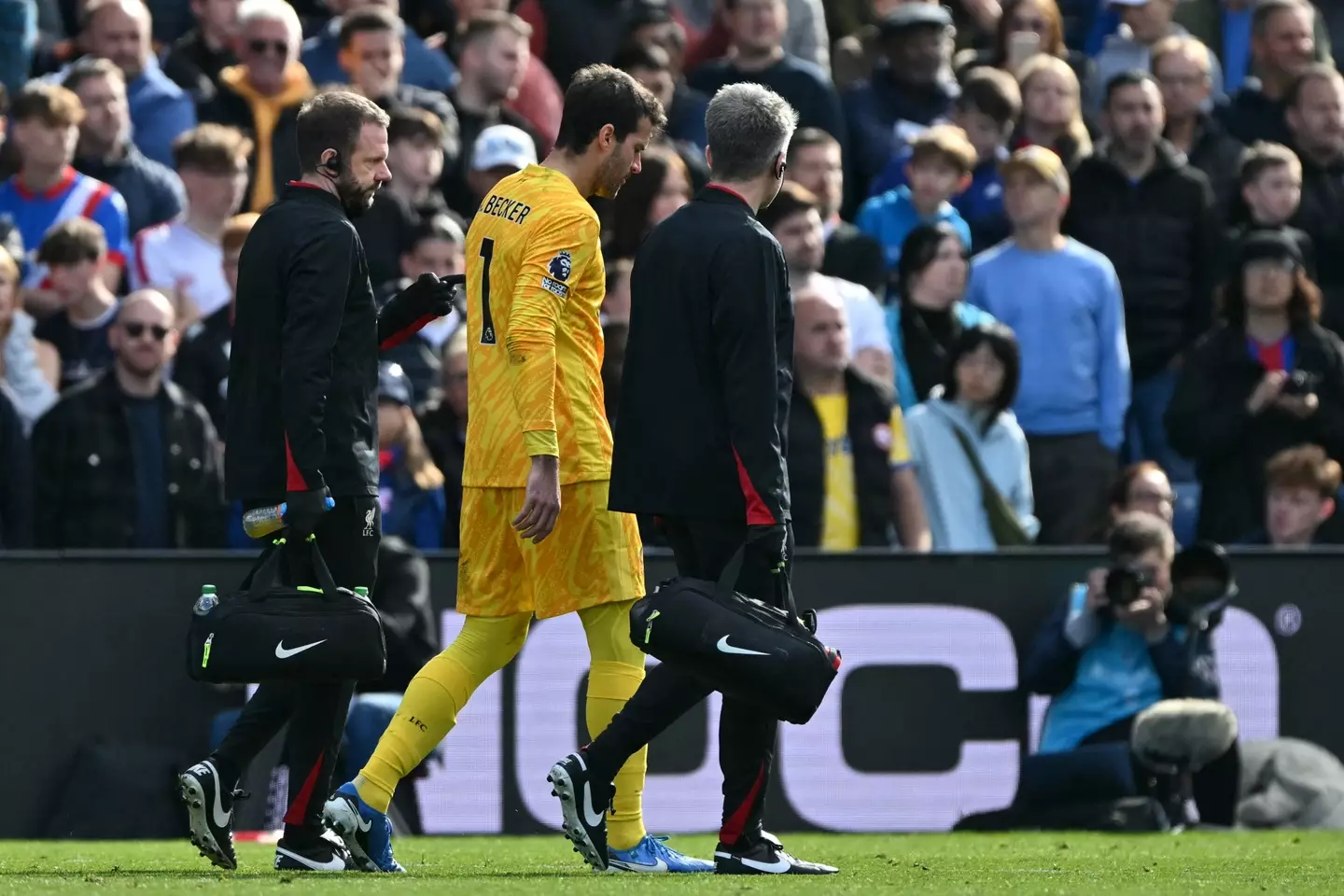 Alisson hobbles off with an injury. Image: Getty