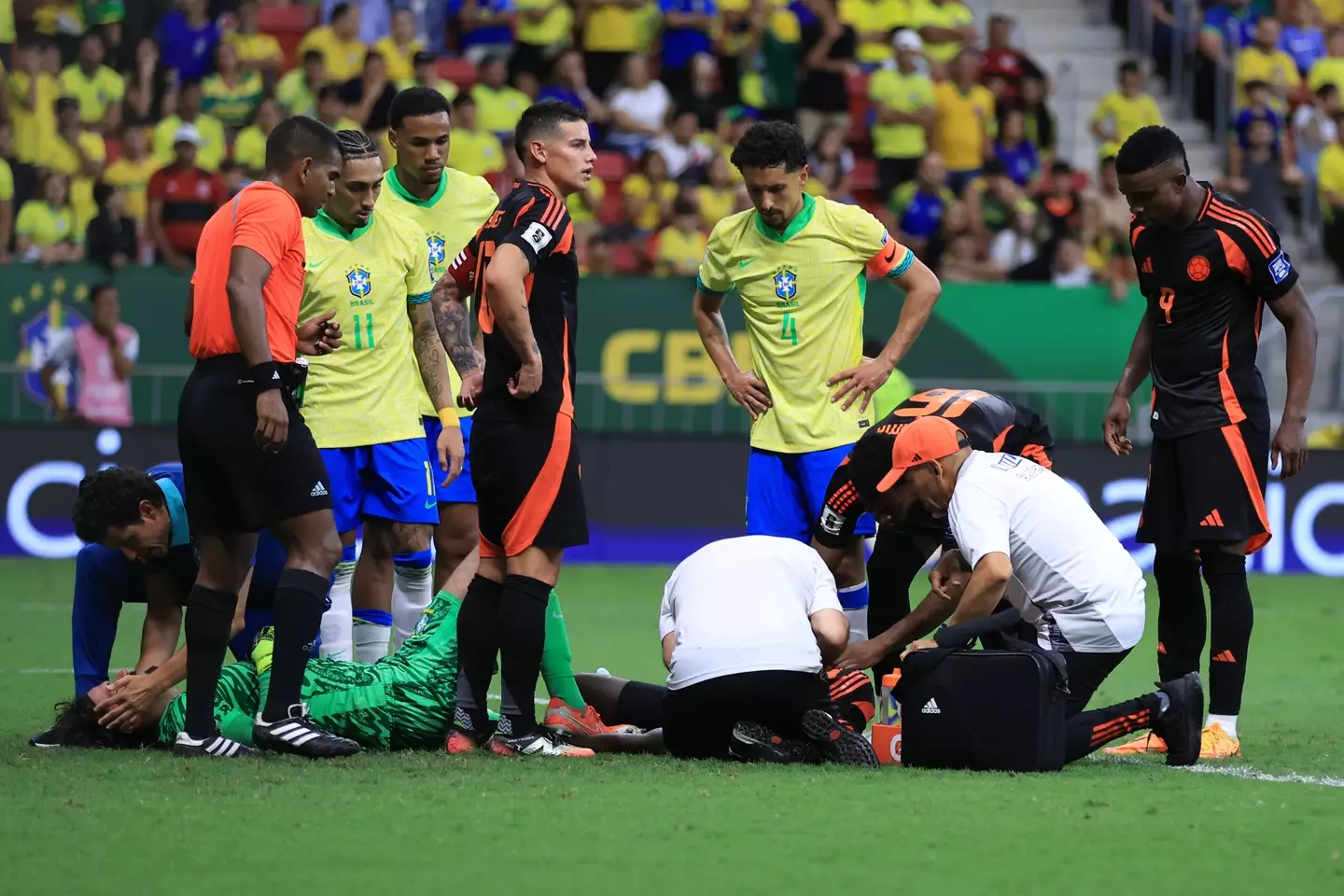 Alisson receives treatment after colliding with Davison Sanchez. Image: Getty