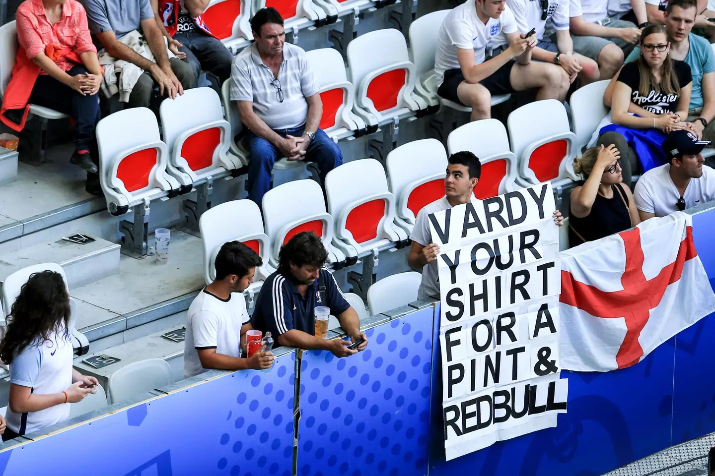 An England fan holds up a sign asking Jamie Vardy for his shirt in exchange for a pint and a Red Bull. Image credit: Getty