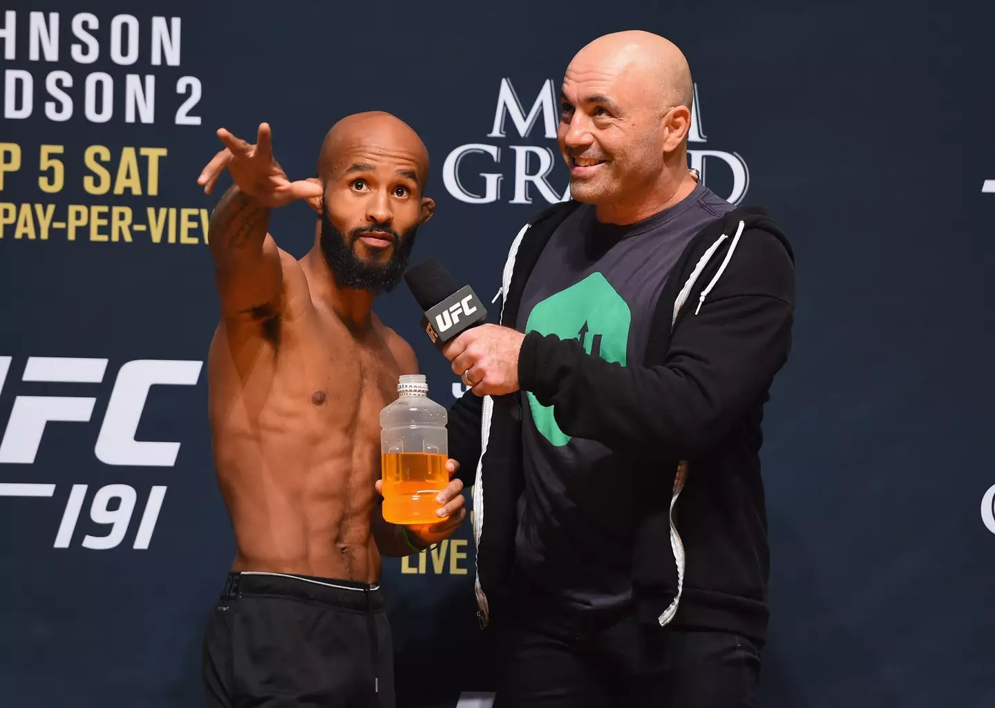 Joe Rogan with Demetrious Johnson ahead of a UFC bout. Image: Getty