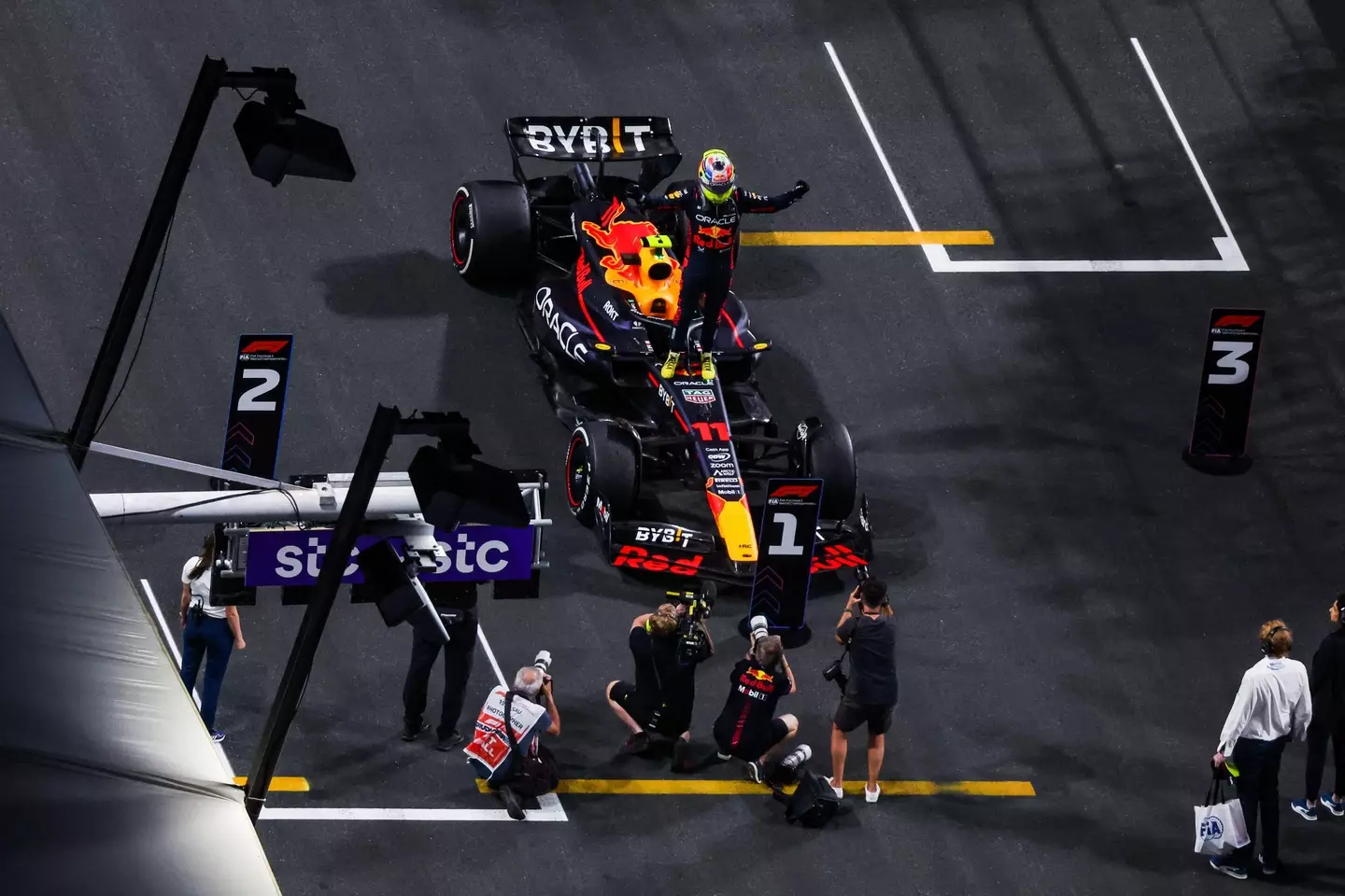 Perez celebrates his win, standing on his car. Image: Alamy