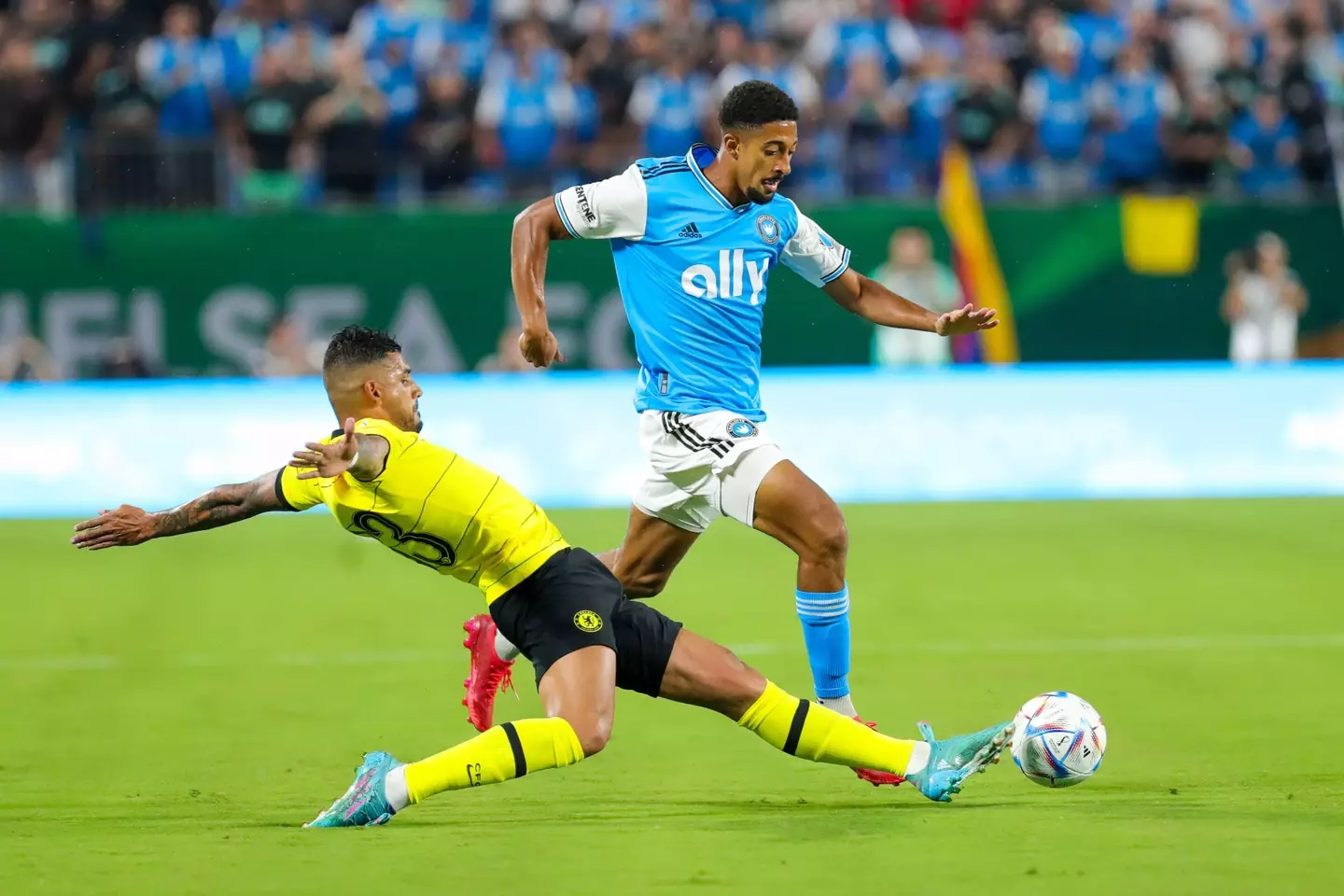 Emerson Palmieri (33) of Chelsea FC slides to defend McKinze Gaines (17) of Charlotte FC during a friendly soccer match. (Alamy)