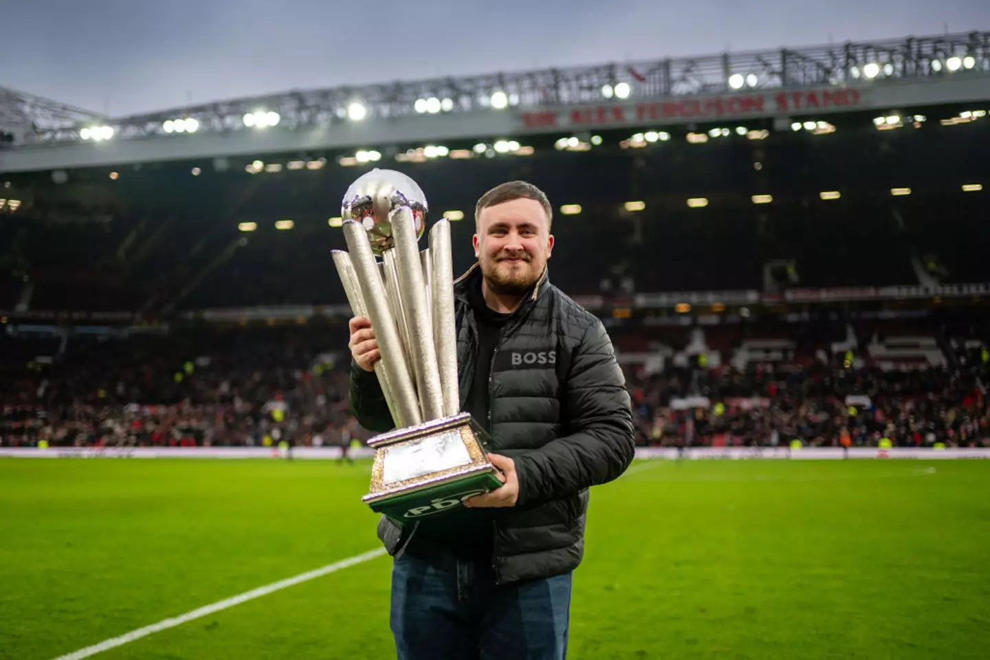 Luke Littler presented his World Darts Championship trophy at Old Trafford earlier this month (Image: Getty)