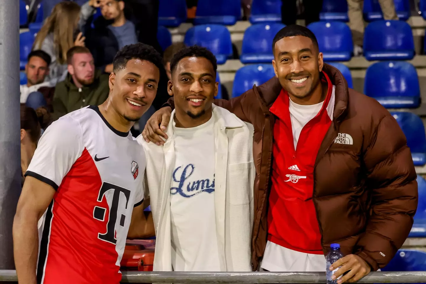 Jurrien Timber (centre) poses for a photo with older brother Dylan (left) and his agent.