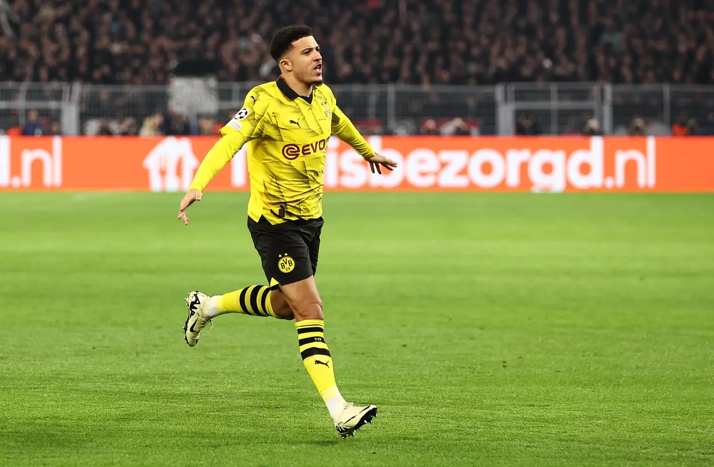 Jadon Sancho wheels away in celebration after scoring a goal for Borussia Dortmund. Image: Getty