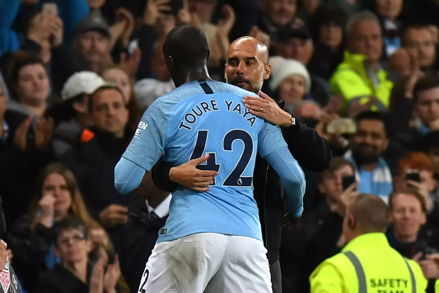 Pep Guardiola and Yaya Toure share a warm embrace during a Manchester City game. Image: Getty