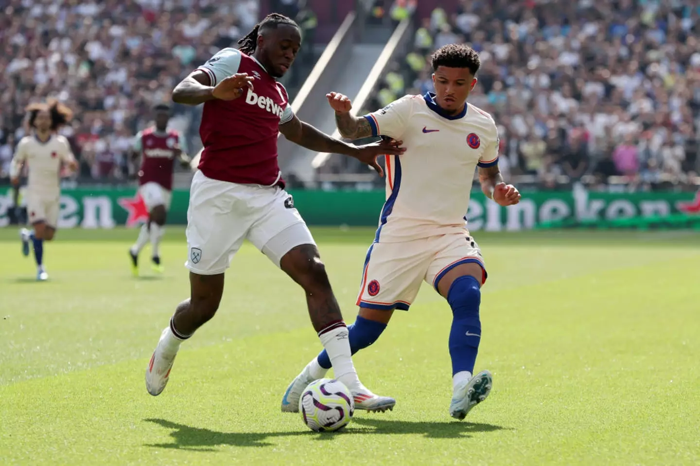 Jadon Sancho battles for the ball with former Man Utd team-mate Aaron Wan-Bissaka -