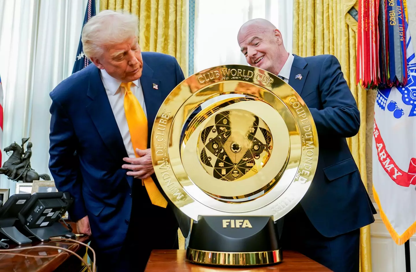 President Donald Trump and FIFA chief Gianni Infantino inspect the Club World Cup trophy (Image: Getty)