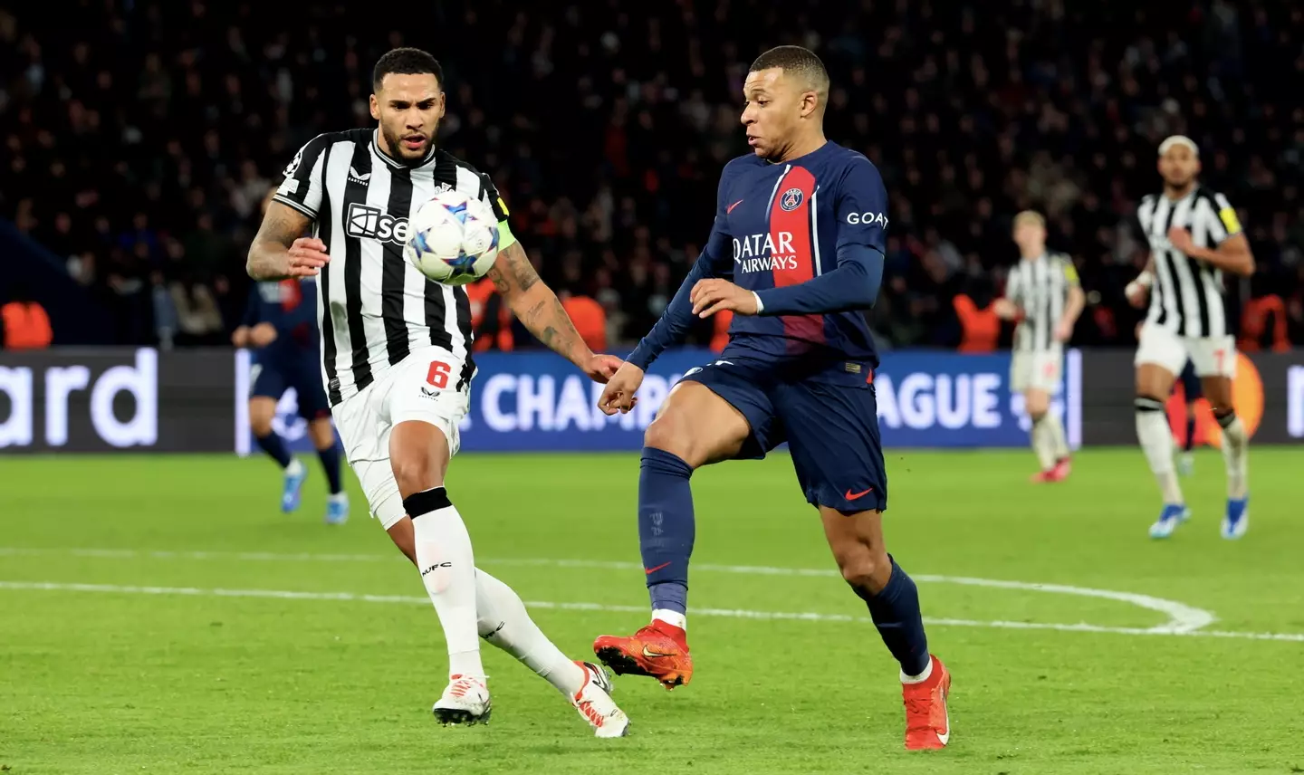 Mbappe tussling with Lascelles, without his armband on. (Image