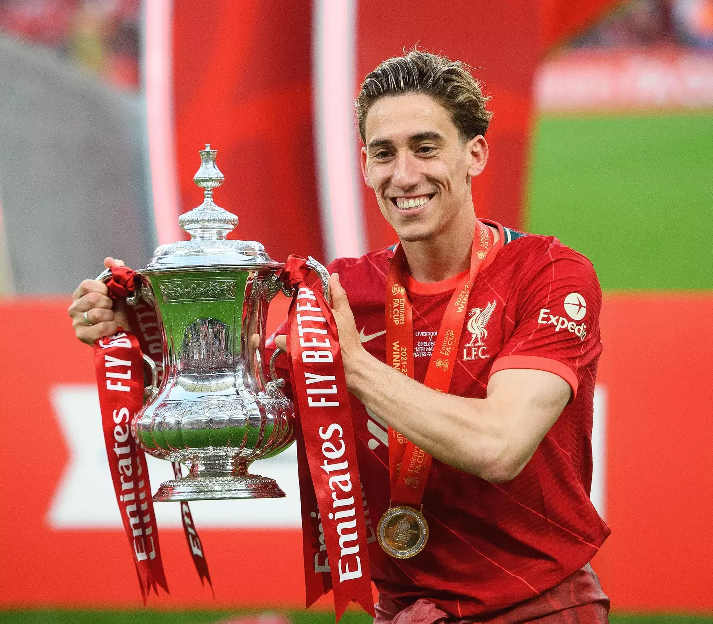 Kostas Tsimikas celebrates with the FA Cup at Wembley Stadium.