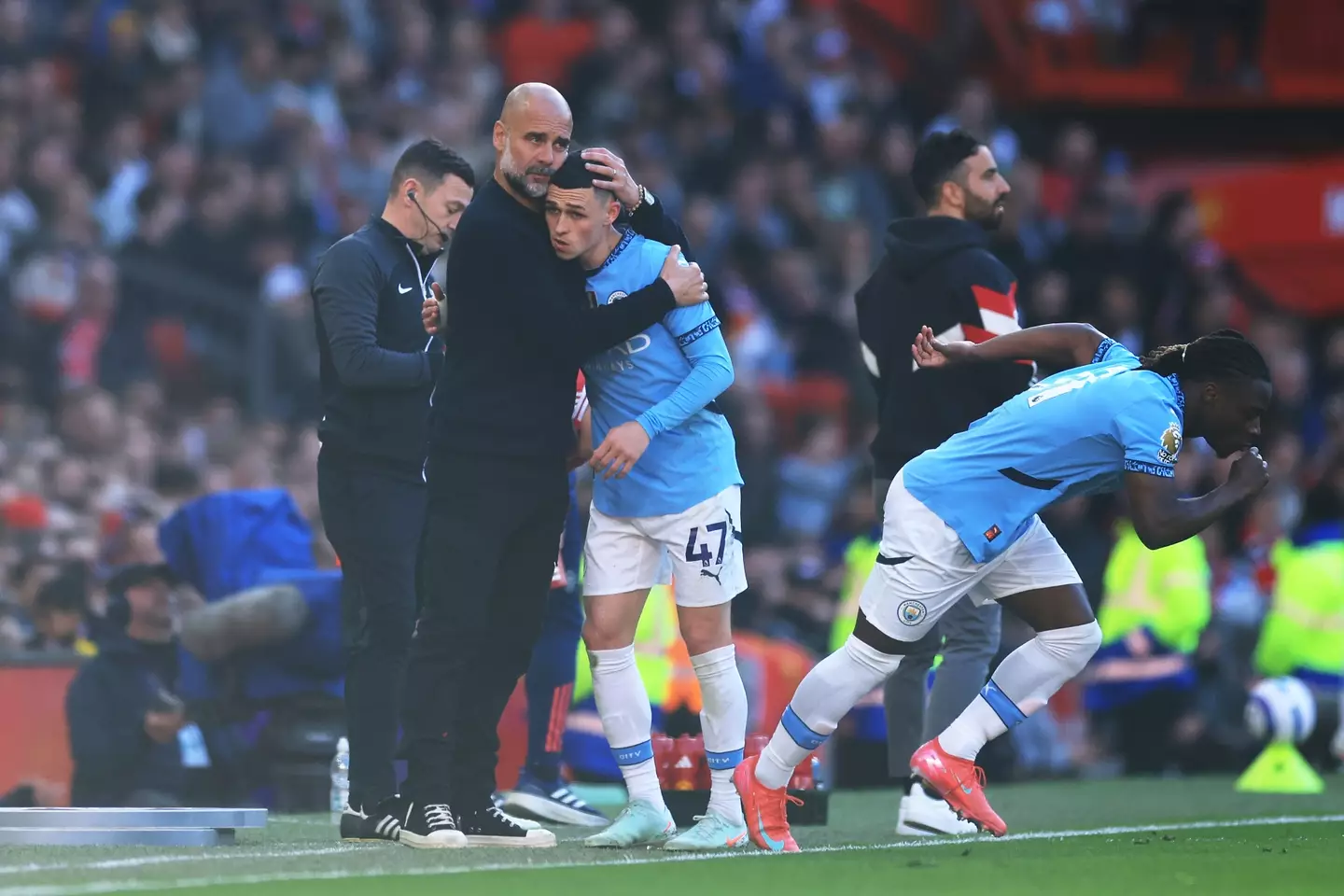Pep Guardiola embraces Phil Foden following his substitution. Image: Getty