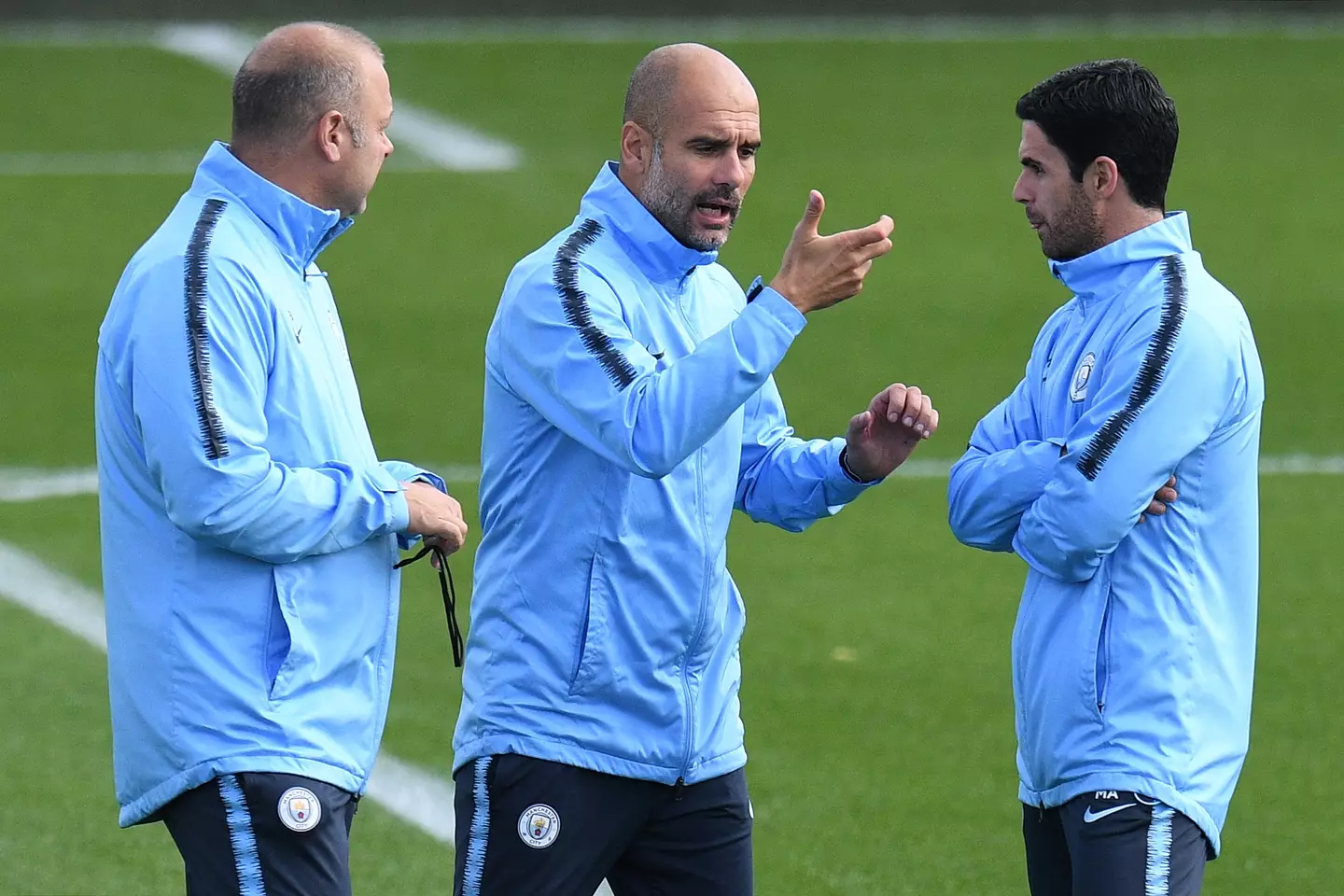 Guardiola in conversation with Arteta in training before his sole game in charge. (Image