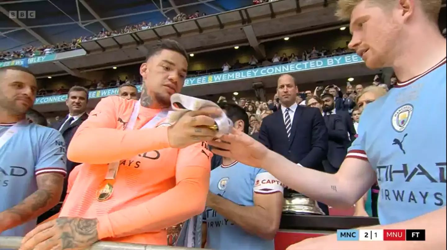 De Bruyne was handed a medal by Ederson. Image: BBC Sport