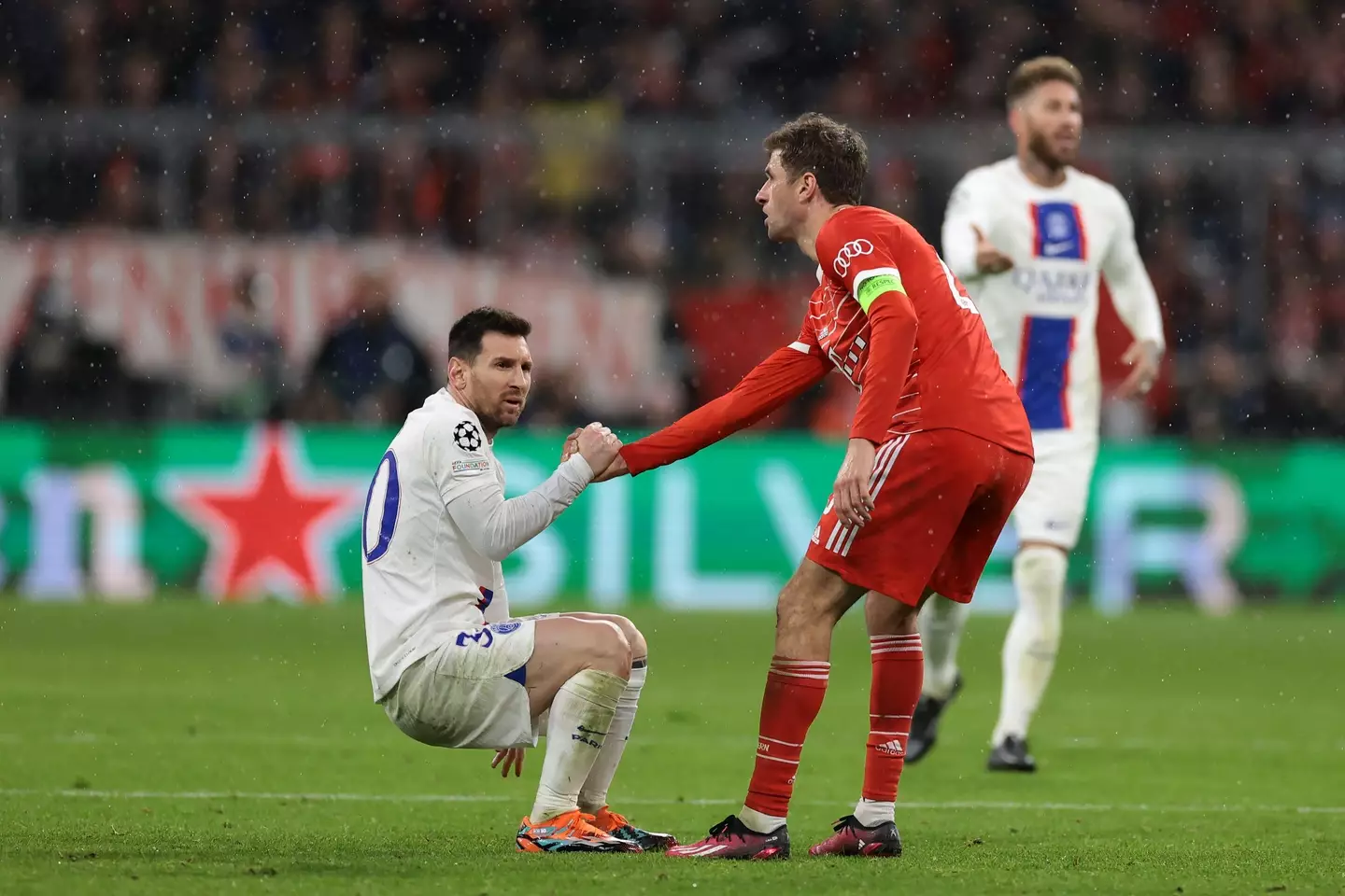 Thomas Muller helps Lionel Messi back to his feet. Image: Alamy 