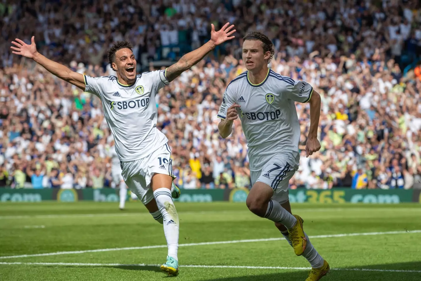 Aaronson celebrates making it 1-0 with Rodrigo, who was captain in Liam Cooper's absence. (Image