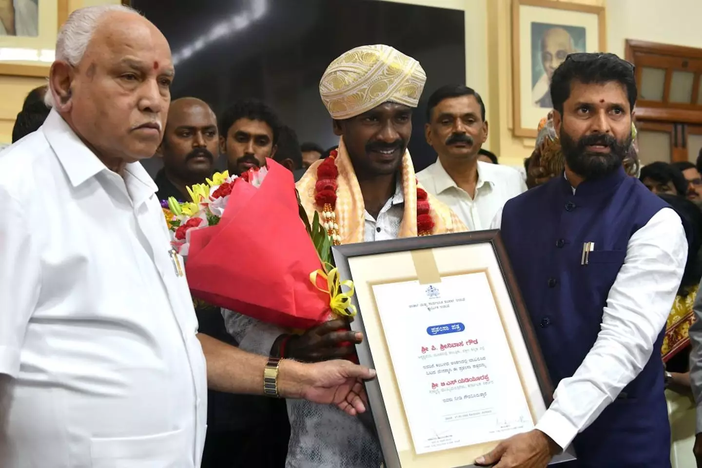 Gowda (centre) was presented with an award by Indian government officials after his record-breaking 2020 run (Image: Getty)
