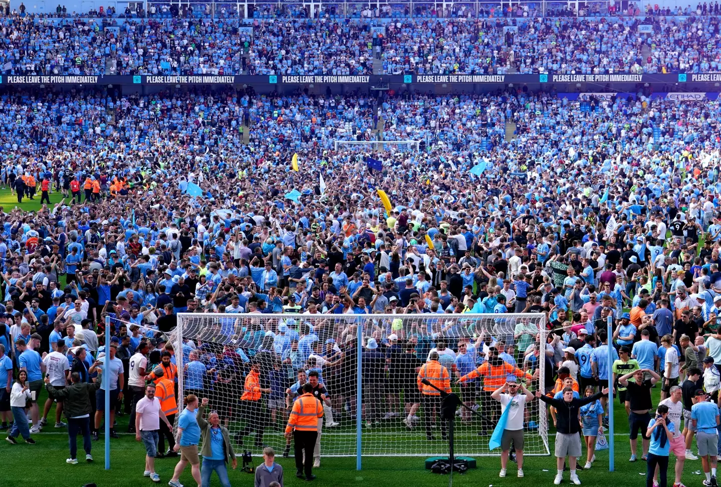 Manchester City fans storm the pitch after securing the 2022/23 title. 