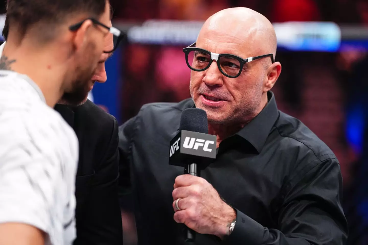 Joe Rogan is still a regular commentator for the UFC, which he does alongside his podcast. (Image: Getty)