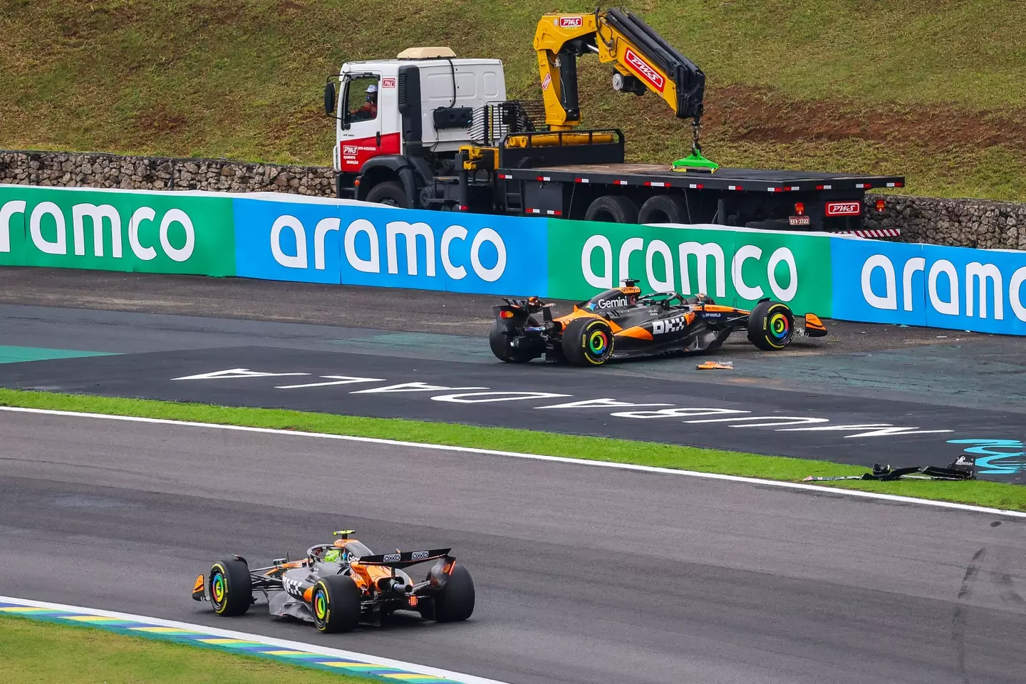 Lando Norris passing the crashed McLaren of Oscar Piastri in Brazil (credit: getty)