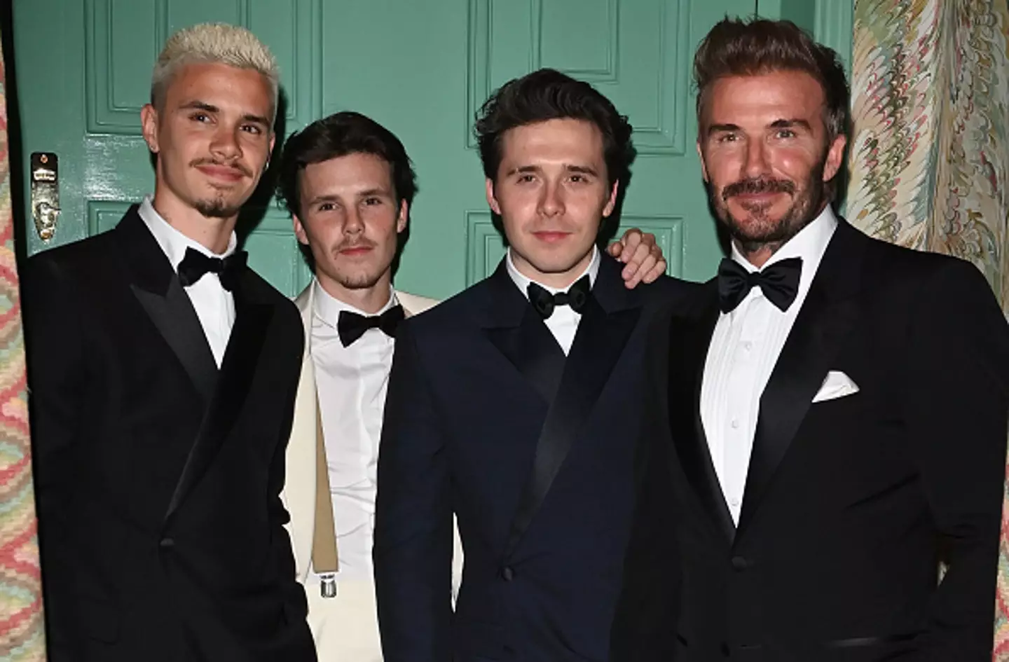 Brooklyn Beckham pictured with brothers Romeo and Cruz, and father David, at Victoria's birthday party in 2024 (Image: Getty)