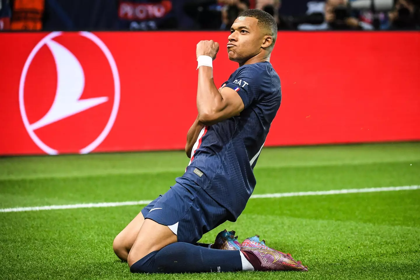Kylian Mbappe wheels away in celebration after scoring against Benfica. Image: Alamy