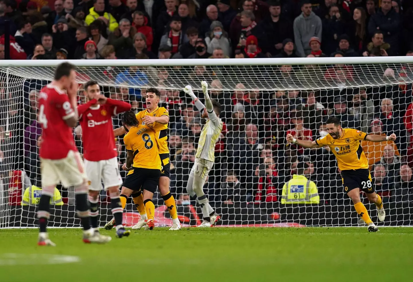 United players look on as Wolves players celebrate at full time. Image: PA Images