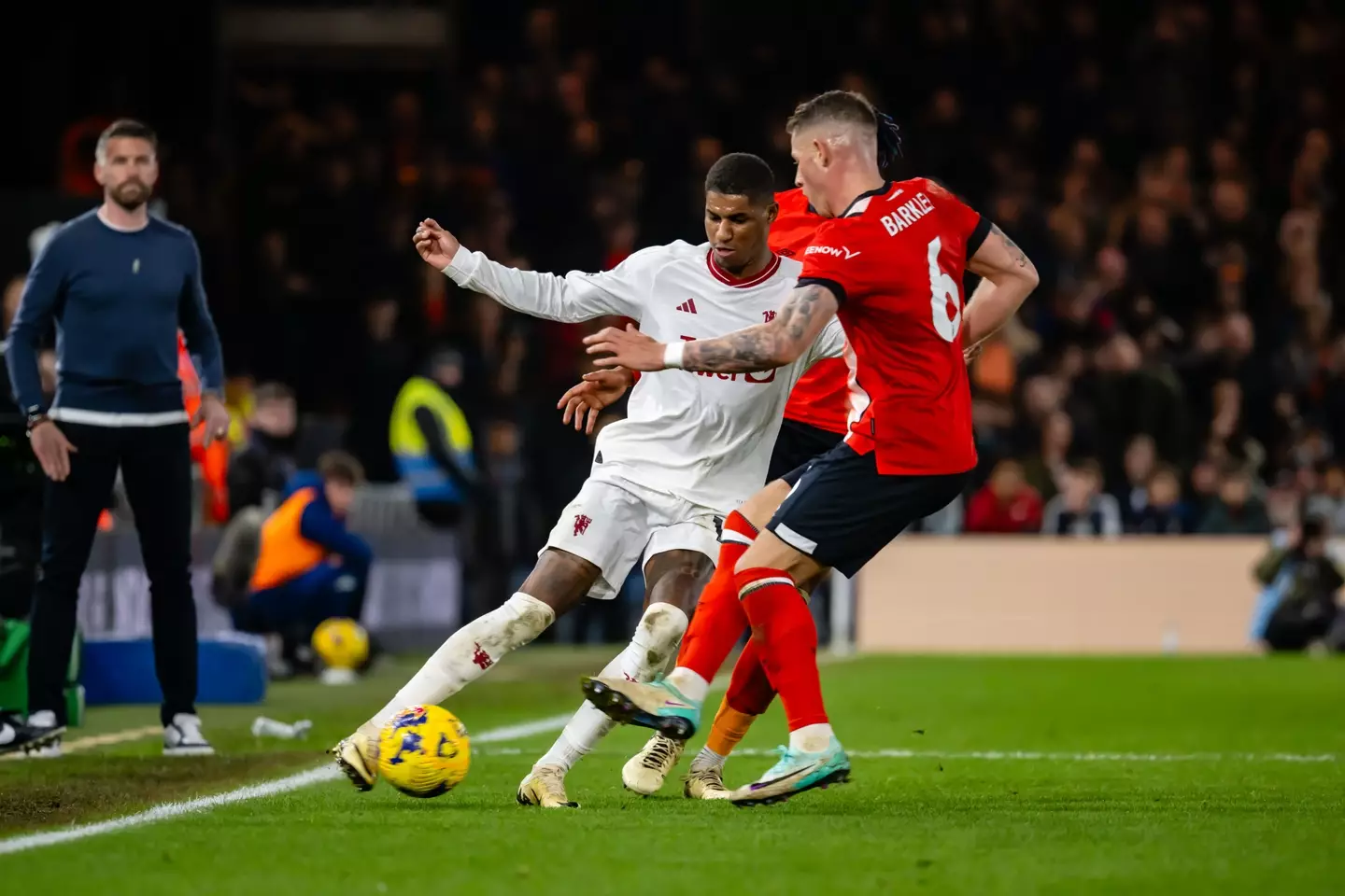 Rashford attempting to dribble past Reece Burke in the game. (Image