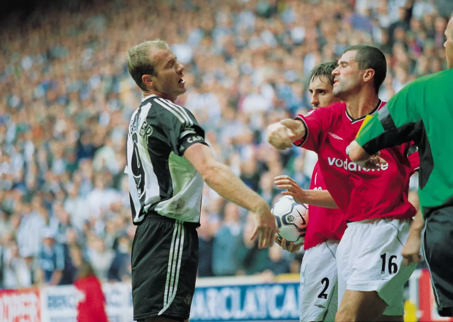 Roy Keane takes a swing at Alan Shearer as Gary Neville watches on. Image: Getty