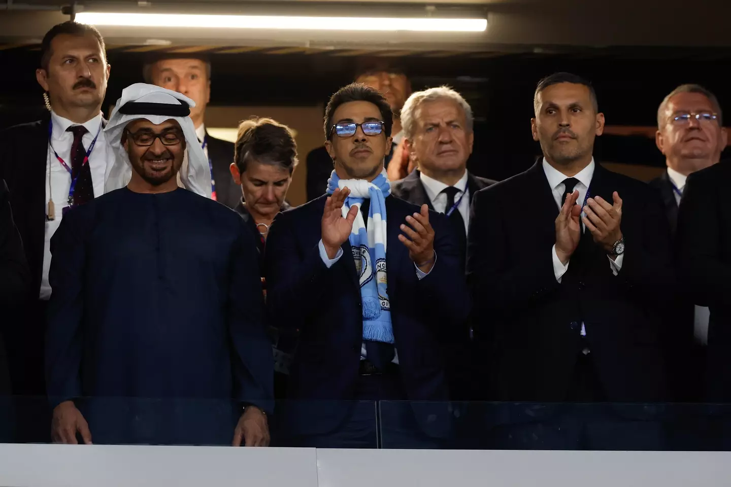 The Manchester City owner Abu Dhabi royal Sheikh Mansour bin Zayed Al Nahyan (centre with scarf) next to chairman Khaldoon Al Mubarrak (right). Image credit: Getty