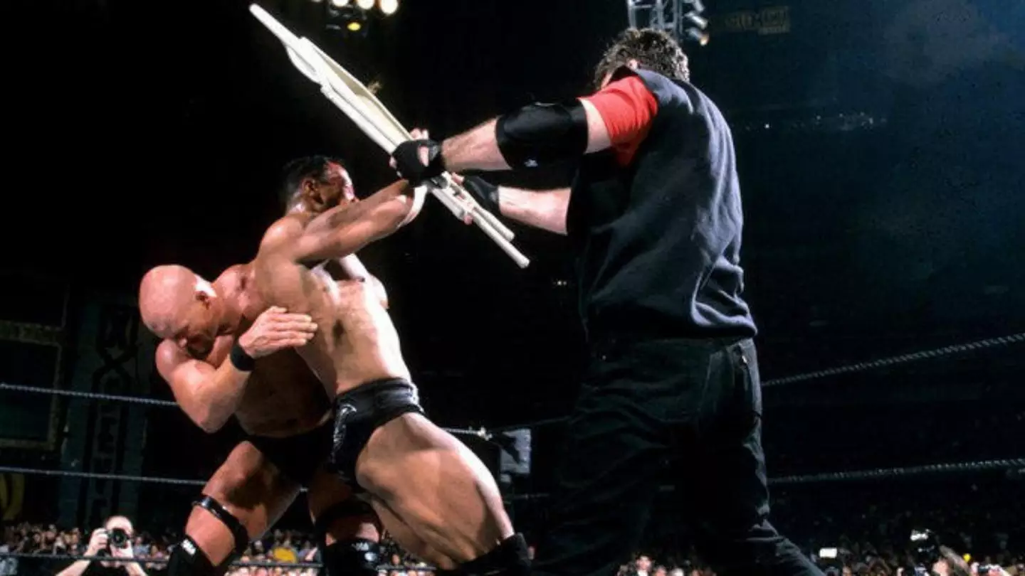 Vince McMahon in the ring with Stone Cold Steve Austin and The Rock during their WrestleMania X-Seven match for the WWF Championship.