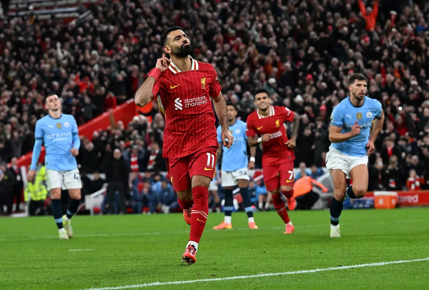 Mohamed Salah wheels away in celebration after scoring against Manchester City. Image: Getty