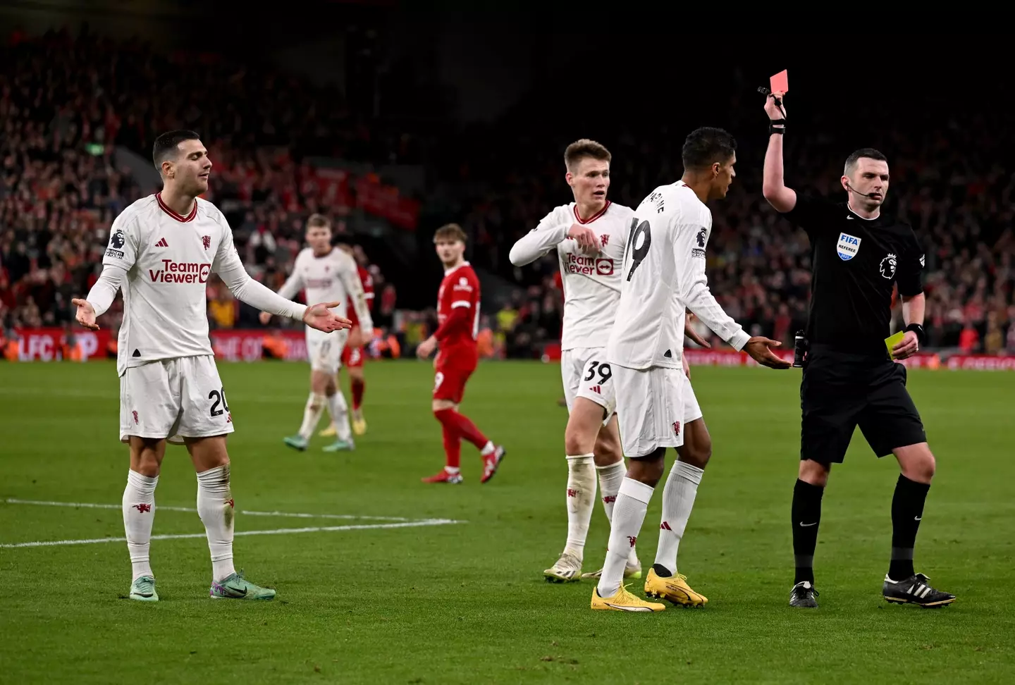 Michael Oliver brandishes a red card to Diogo Dalot during last season's fixture between Liverpool and Manchester United. Image: Getty