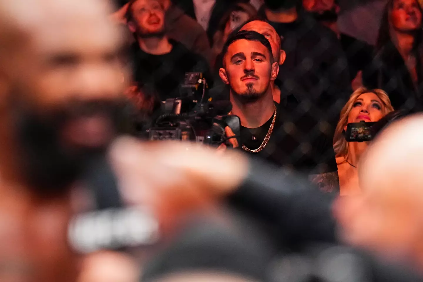 Tom Aspinall looks on as Jon Jones speaks after his UFC 309 victory. Image: Getty