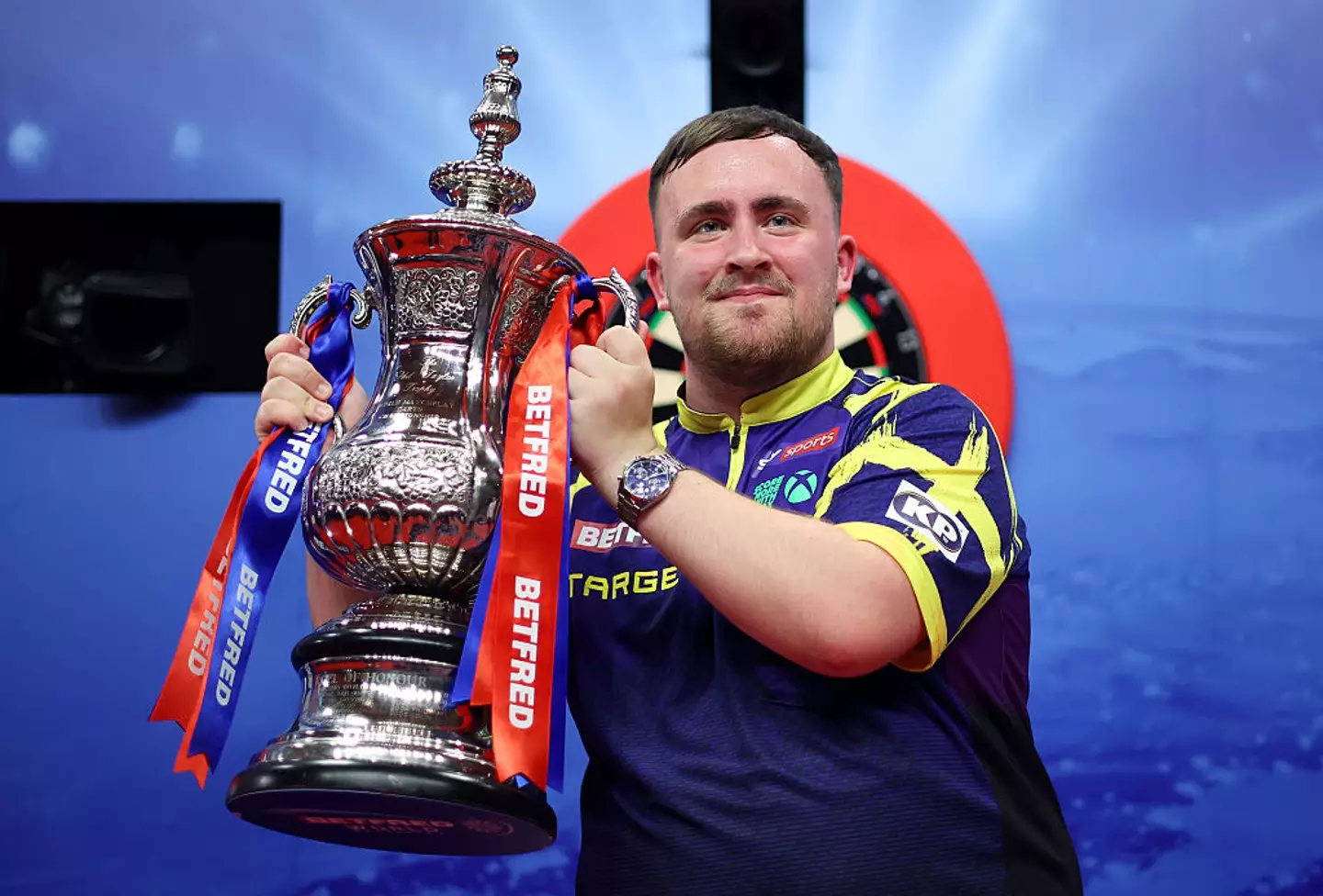 Luke Littler lifted the Phil Taylor Trophy after defeating James Wade (Image: Getty)