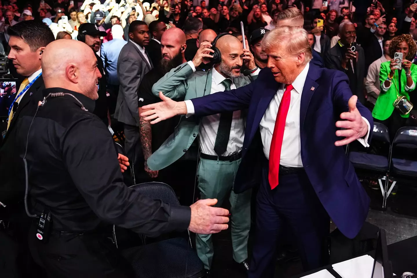 Joe Rogan and Donald Trump share an embrace at UFC 309. Image: Getty