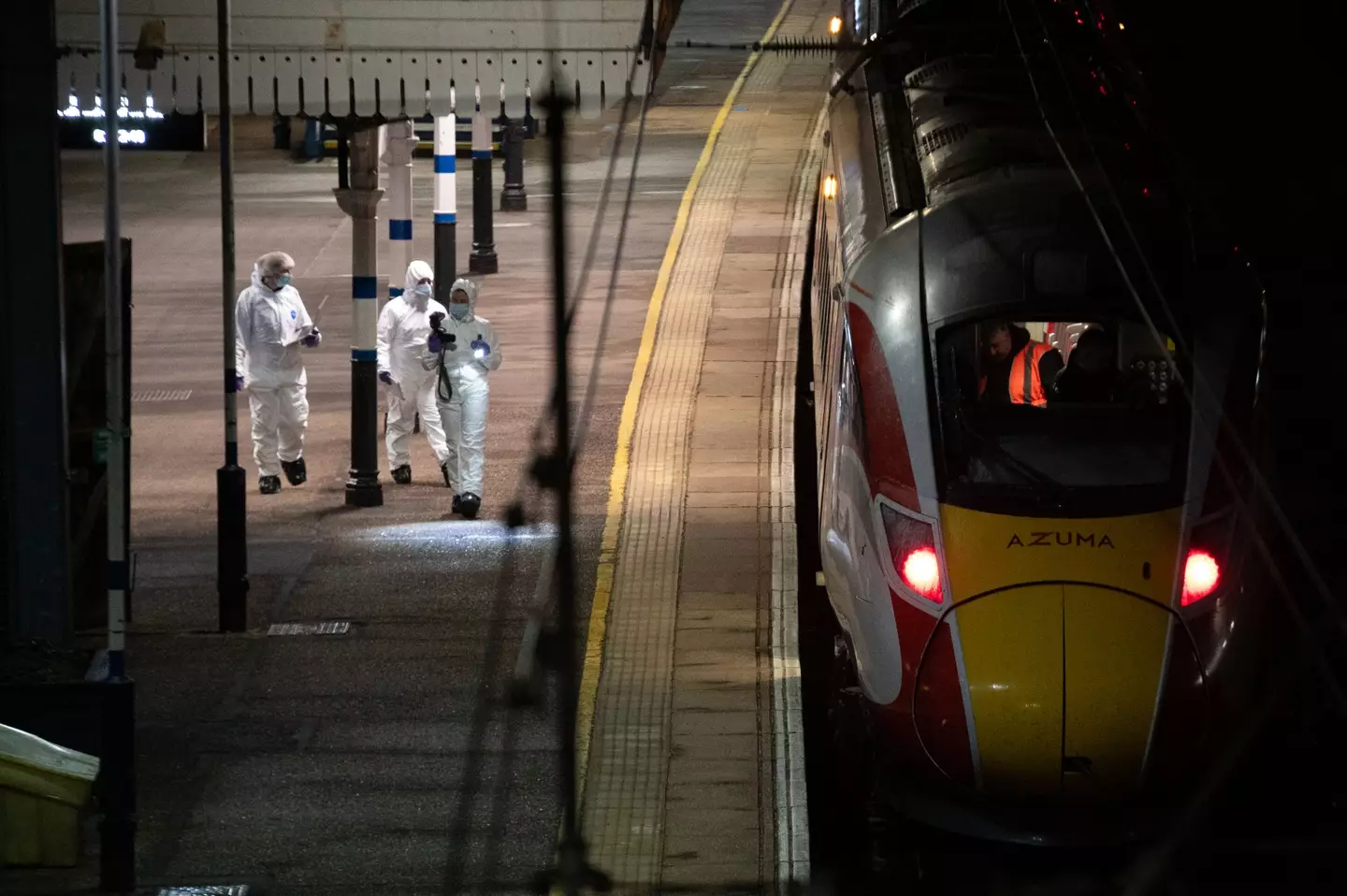 Crime scene investigators walk along a train platform at Huntingdon Station on November 2, 2025. Image credit: Getty