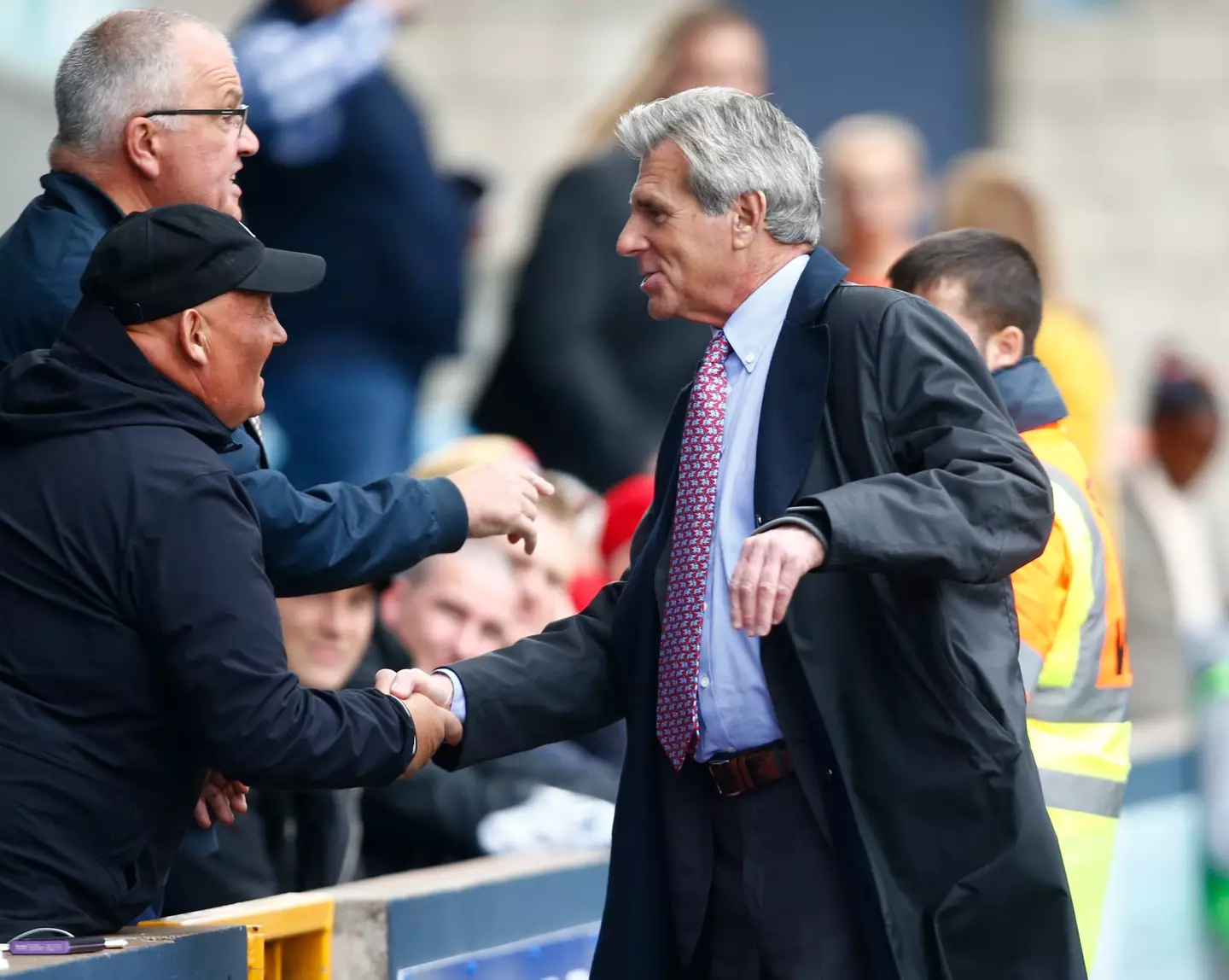 John Berylson shakes hands with a Millwall fan. Image: Getty